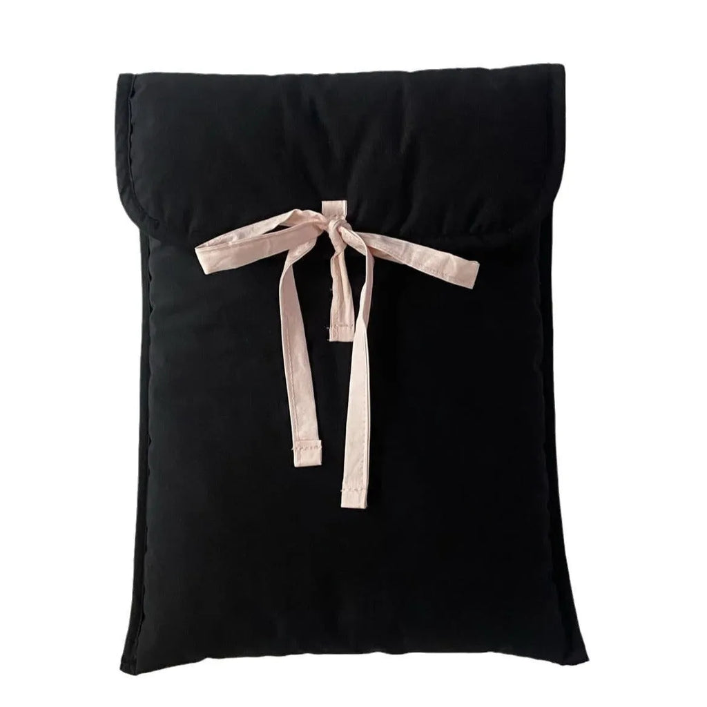 Women's black and white quilted nylon laptop bag with a ballet-style bow.