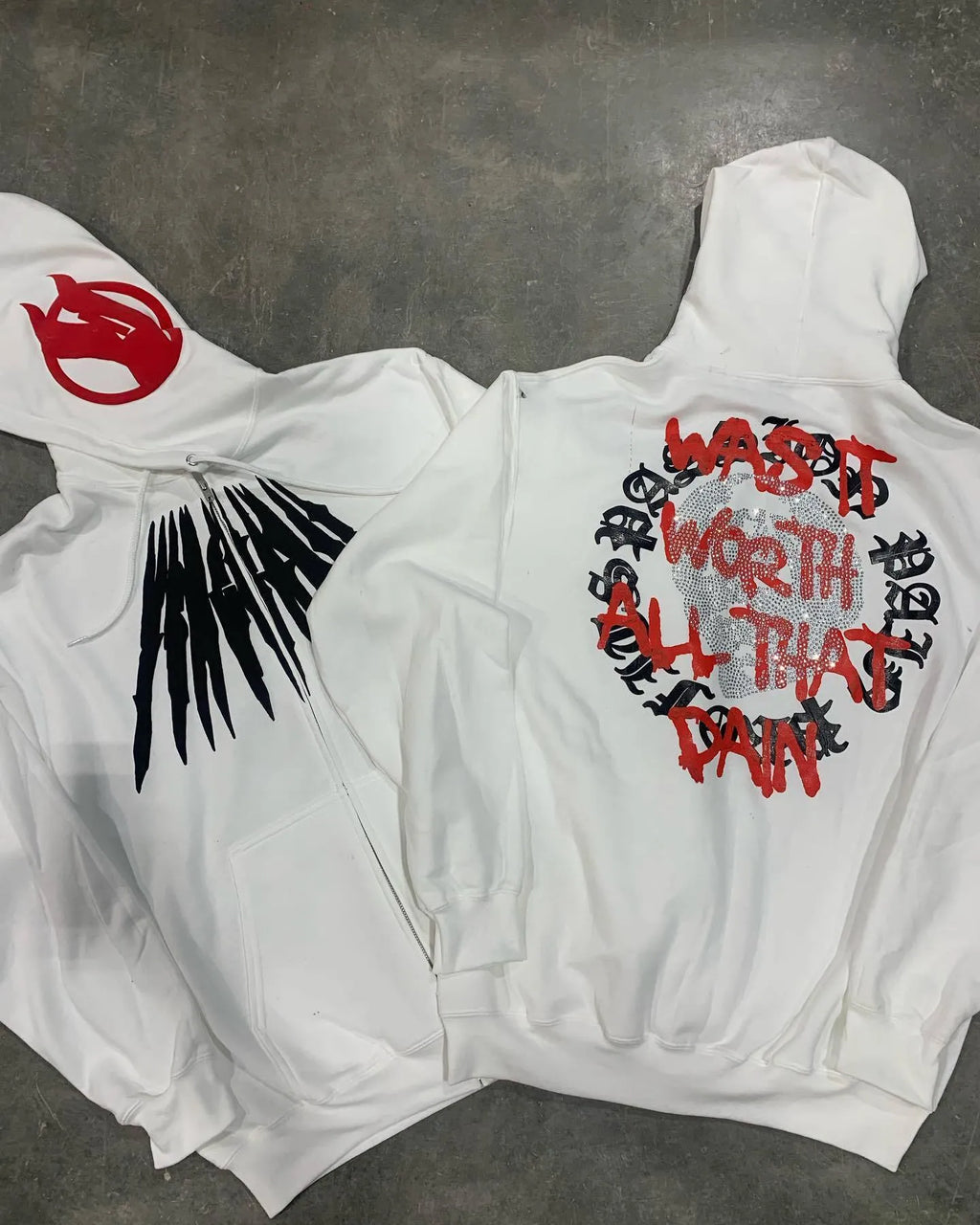 Black loose hooded sweatshirt with white skull print and rhinestone details on the front