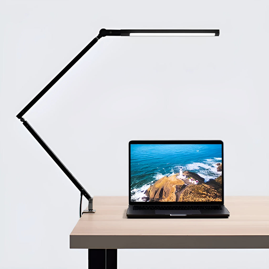 Adjustable aluminium desk lamp with clip base and remote control, shown in dazzling black finish.