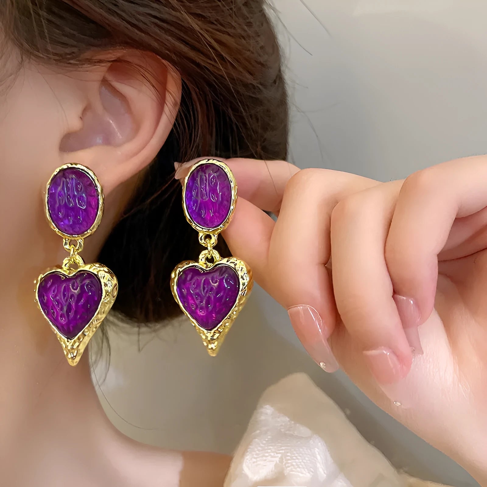 Purple, red, green, and yellow and white alloy pleated oval love heart stud earrings on silver posts.