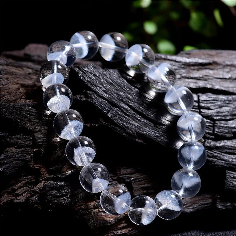 Women's white crystal ghost pyramid bracelet with Ruyi design element showing multiple purity size options
