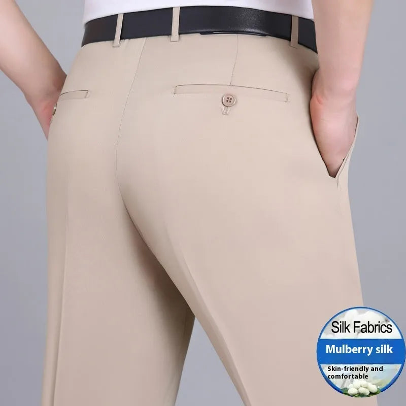 Men's straight-leg suit trousers in a dark blue colour, showing high waist and business cut.