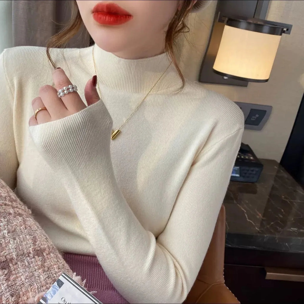 Women's slim fit knitted long sleeve top in viscose fabric, shown in apricot colour.