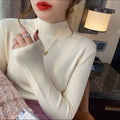 Women's slim fit knitted long sleeve top in viscose fabric, shown in apricot colour.