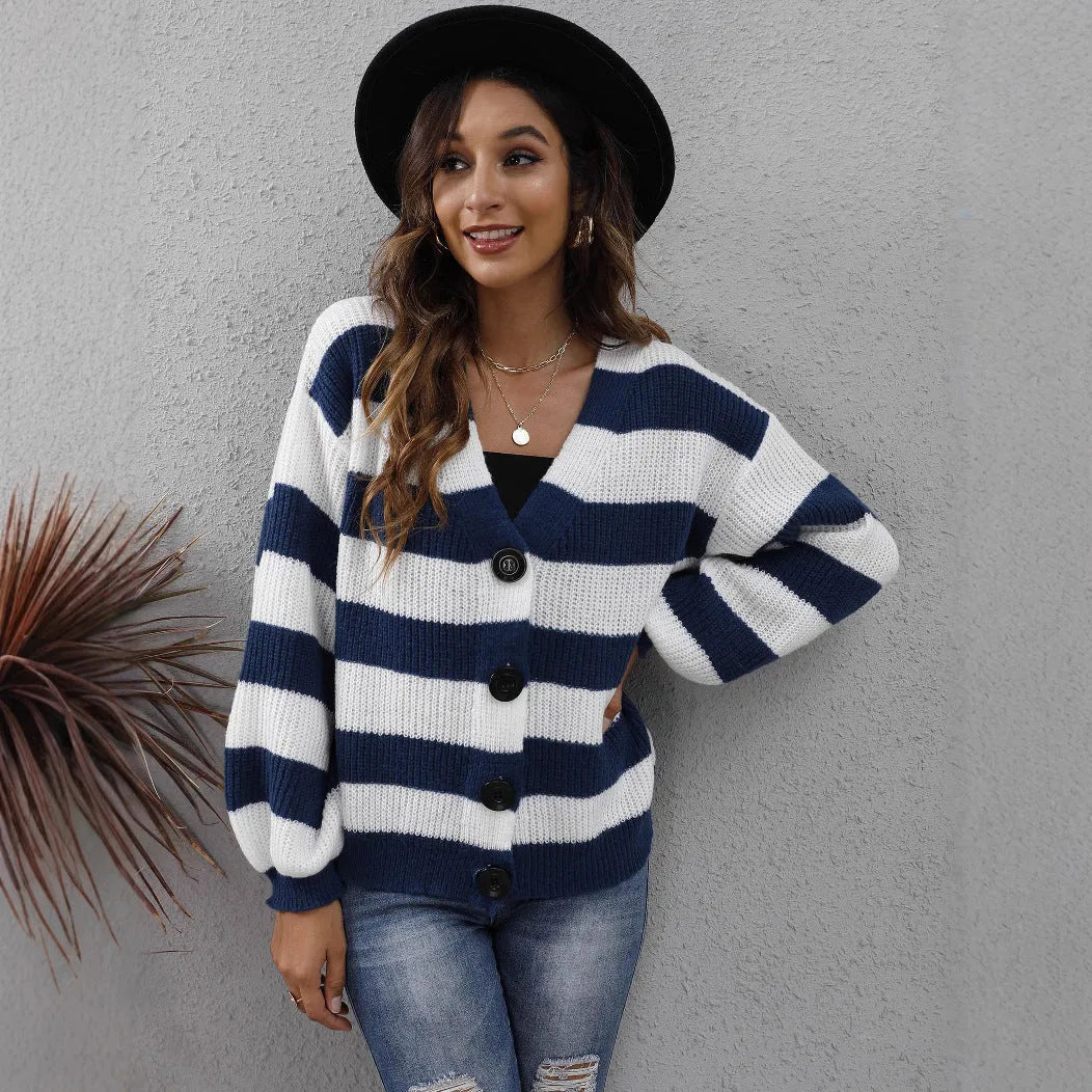 Blue striped women's cardigan sweater with button front and regular sleeves on a hanger.