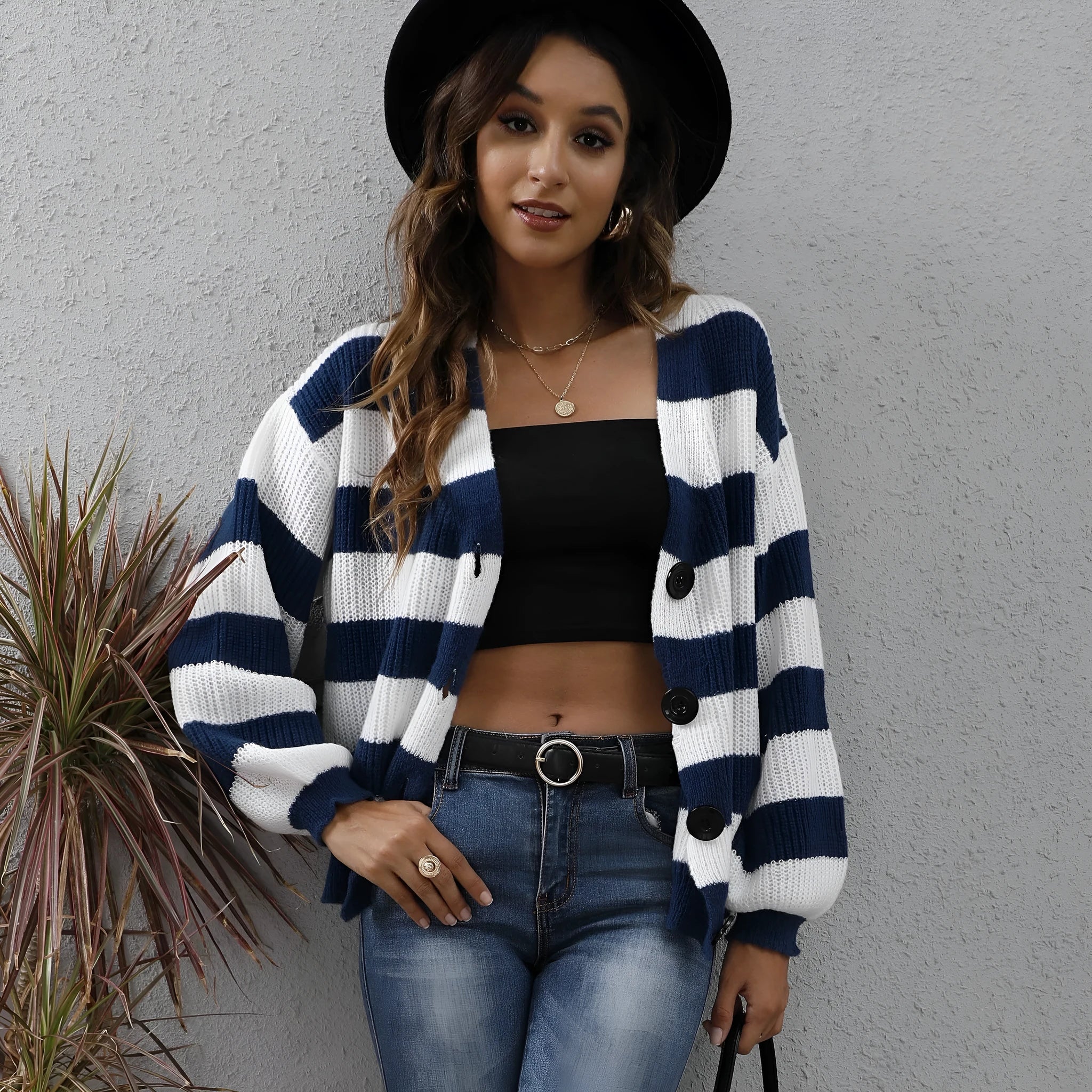 Blue striped women's cardigan sweater with button front and regular sleeves on a hanger.