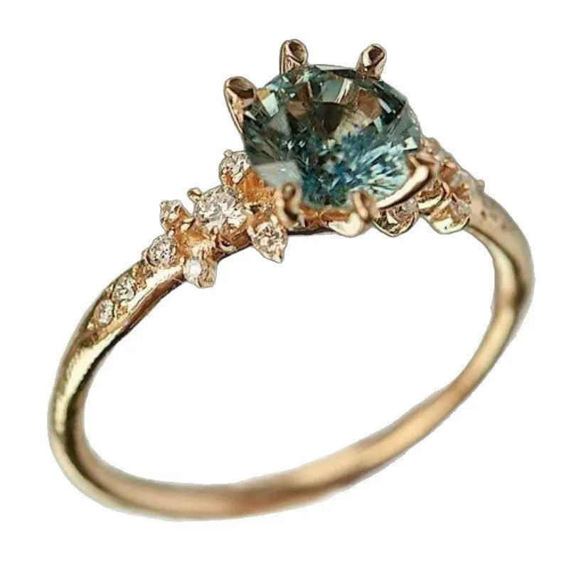 Gold plated geometric claw ring with a zircon stone, showing chamfered square pattern on band.
