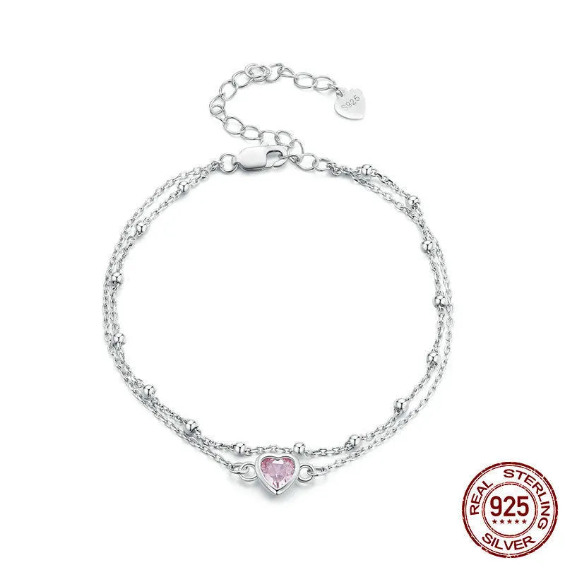 Sweet girlish style 925 sterling silver bracelet with a small heart-shaped charm on a chain.