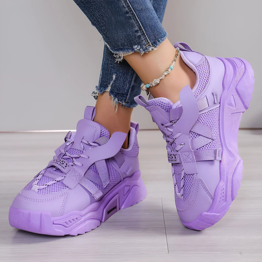 Women's purple mesh platform dad shoes with front lace-up design on a plain background.