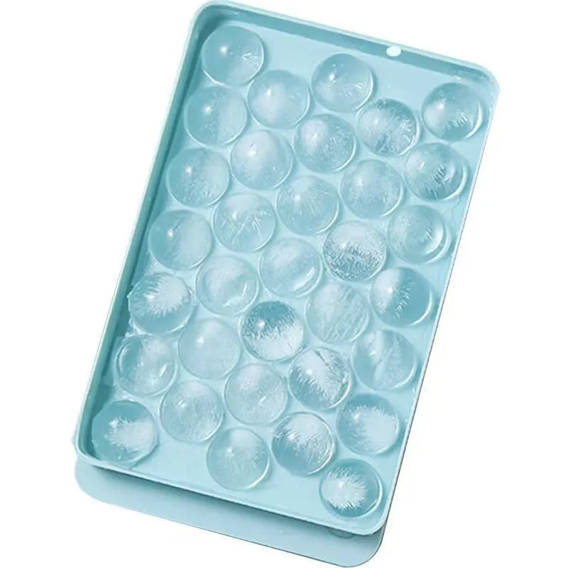 Blue silicone round ice cube tray with lid showing 33 circular moulds
