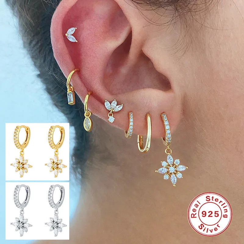 A pair of women's S925 sterling silver snowflake pendant earrings with a geometric design, available in yellow gold or white gold colour finishes.