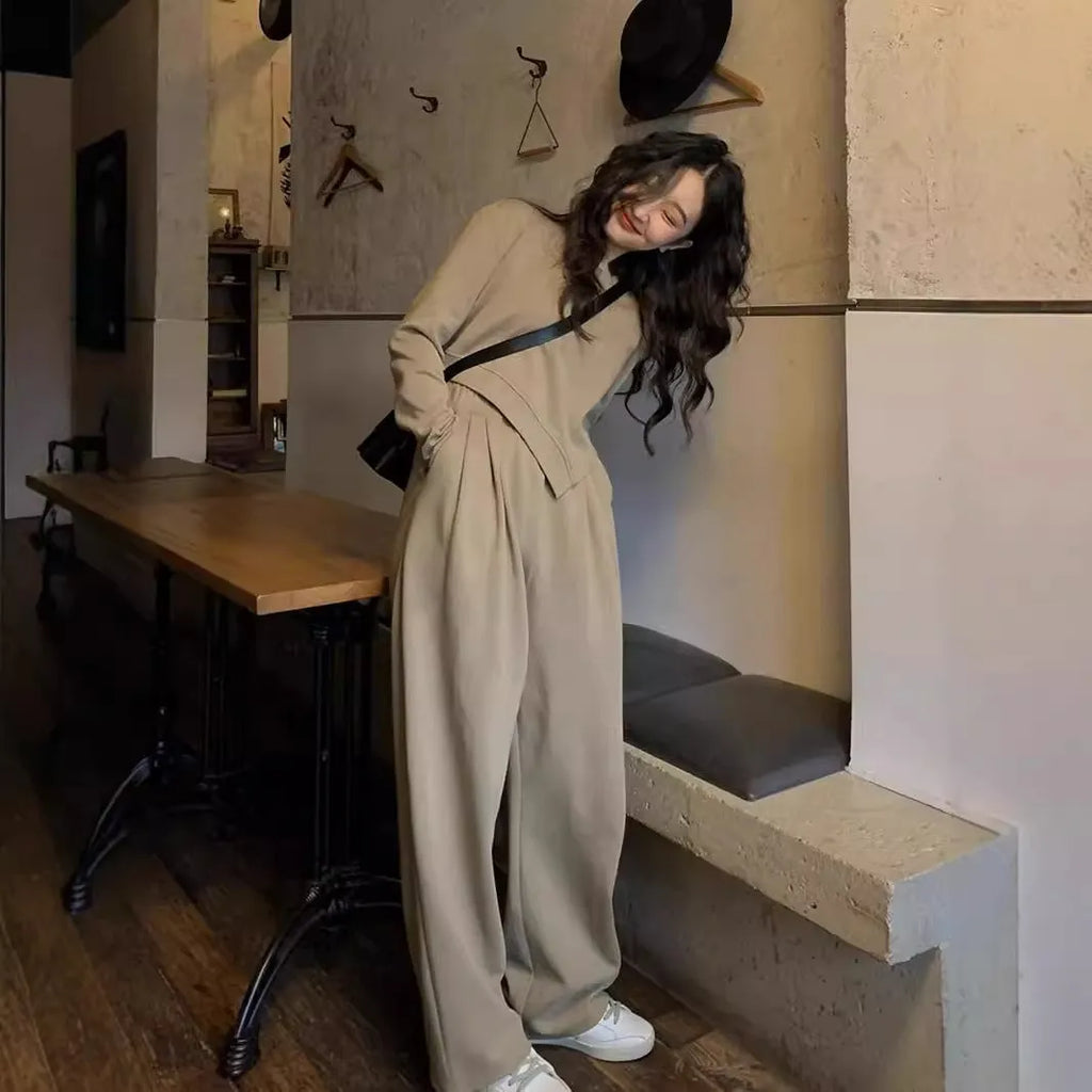 Women's khaki loose-fit casual sports suit with long sleeve top and trousers on a hanger.
