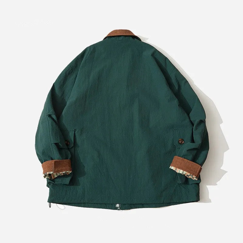 Green casual polyester jacket for men and women with side pockets on a hanger.