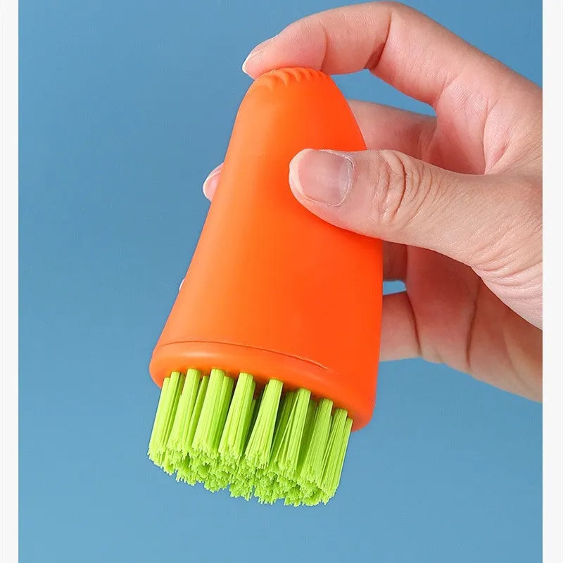 White and orange carrot-shaped nylon kitchen cleaning brush with dense bristles.