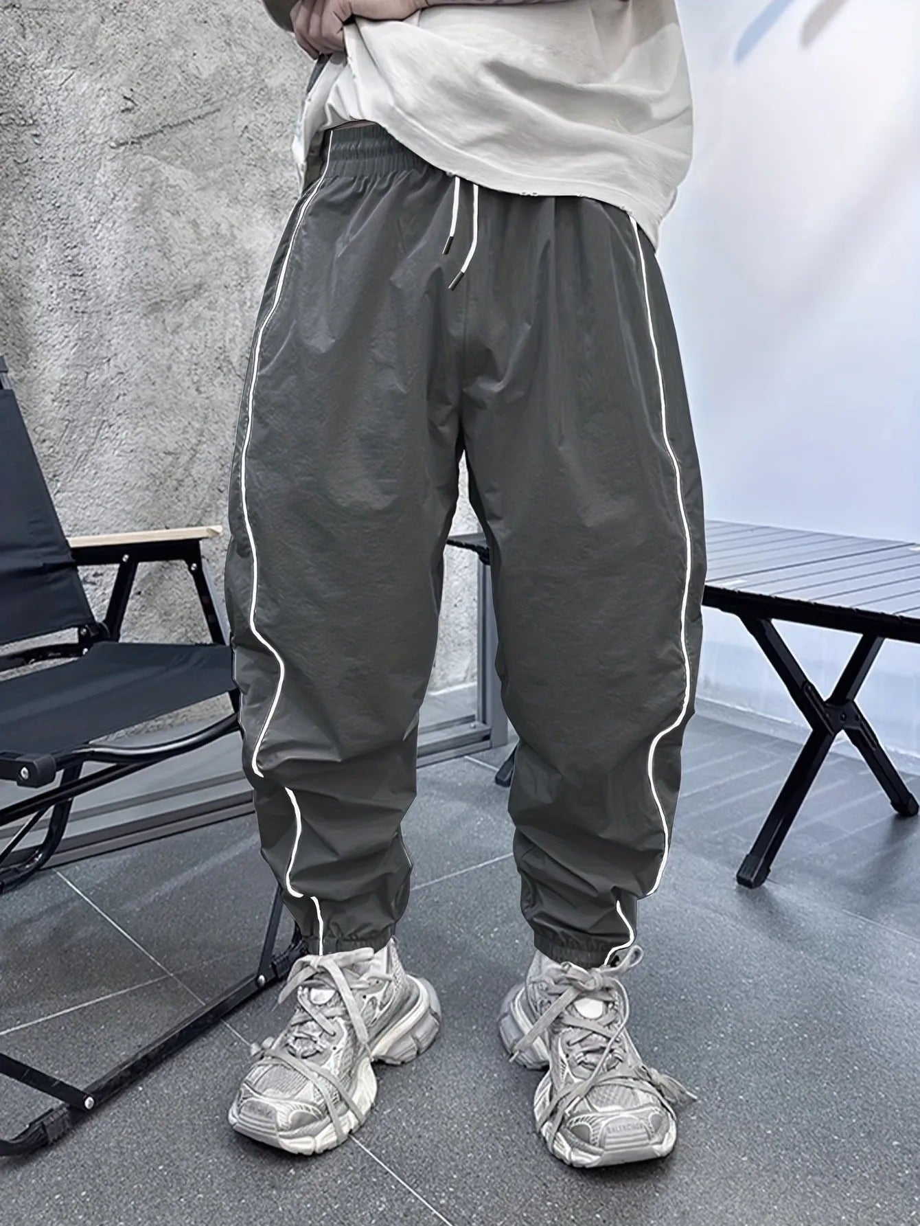 Man wearing blue loose-fit cropped sports trousers made from bamboo fibre.