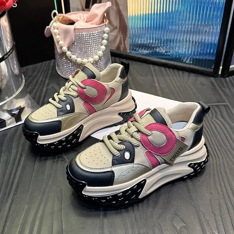 Pair of thick-soled leather sports casual shoes with wedge heels and front lace-up fastening.