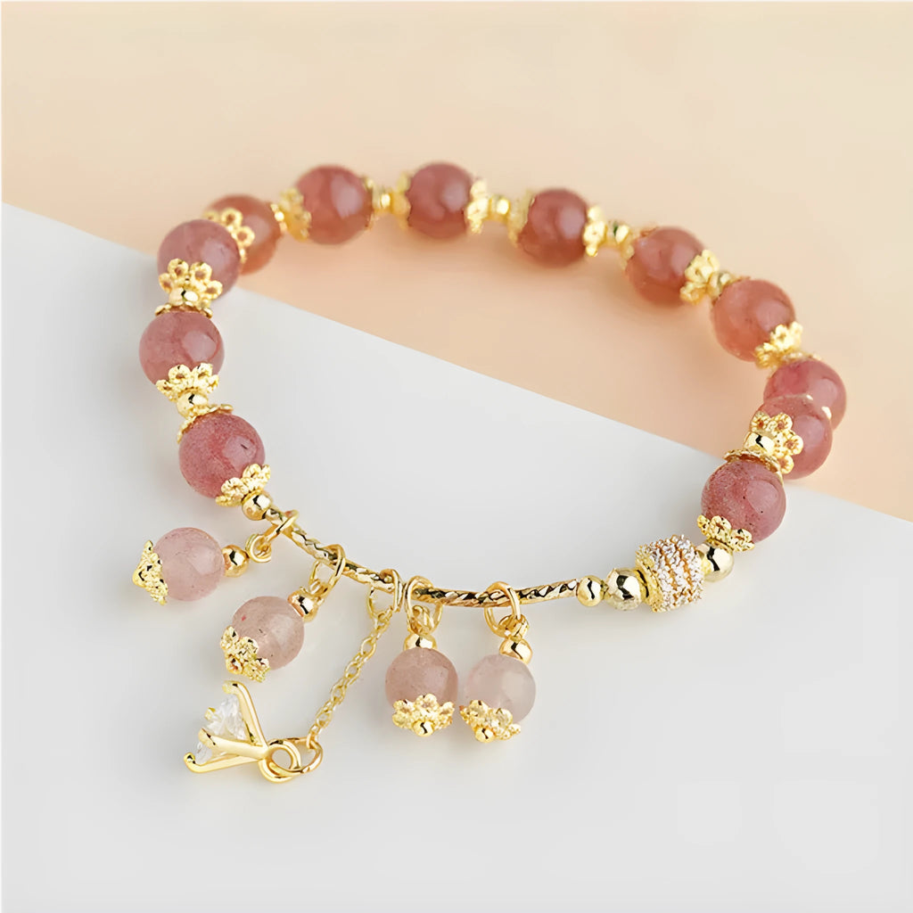 Pink women's bracelet with heart-shaped strawberry quartz crystals and pearl bead accents on adjustable band