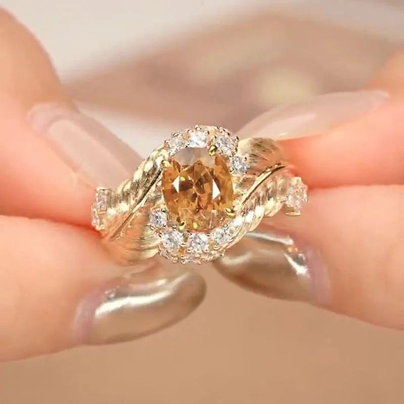 Gold-coloured copper feather ring with geometric design and yellow zircon inlay details