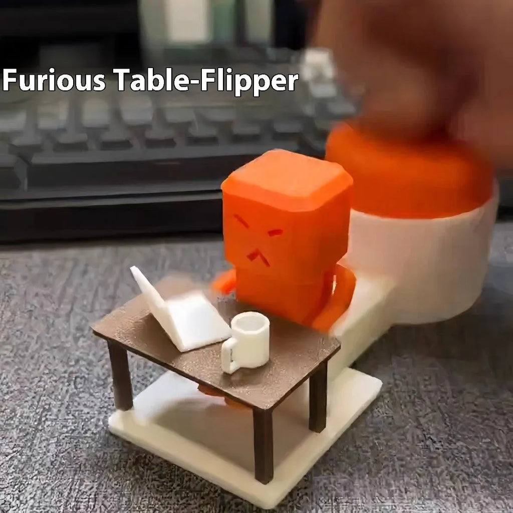 Orange plastic Take a Shot vent decompression toy with a rotating table on a desk.