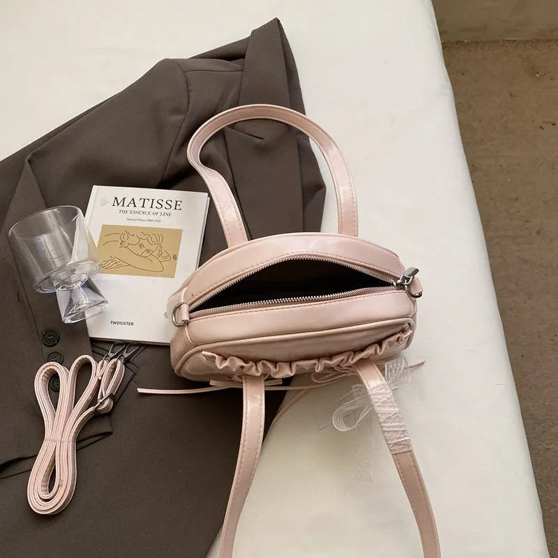 Women's PU bandage bow handbag in milky white with shoulder strap and sewing thread detailing