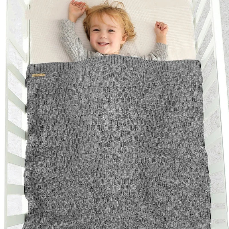 Solid colour infant blanket with raised line texture, shown in a light green colour.