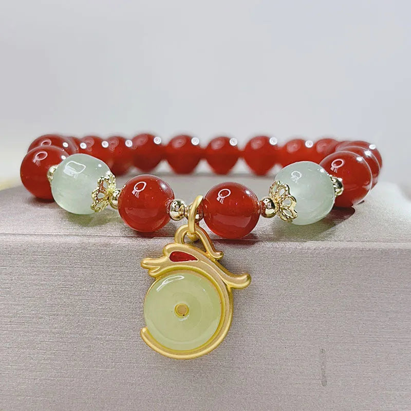 Handcrafted red agate bracelet for women with dragon charm, Chinese style design.