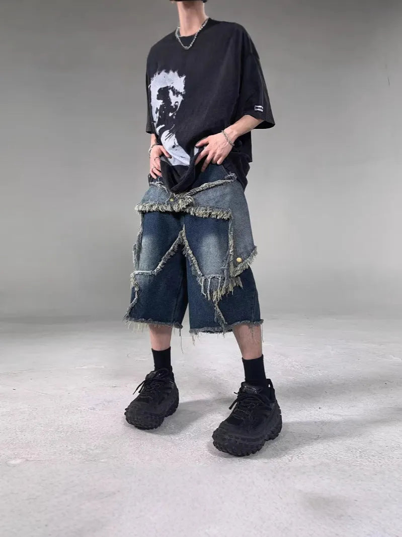 Blue denim shorts with a frayed five-pointed star detail on the leg, showing a loose, retro fit.